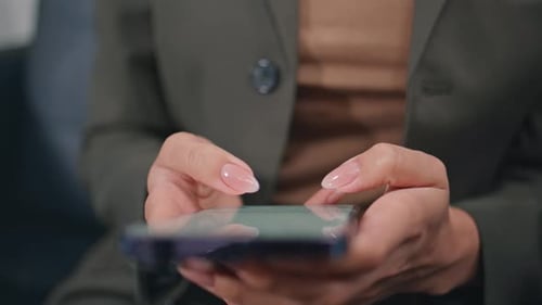 Woman Fingers Touching Cellphone Touchscreen in Modern Office Interior Closeup