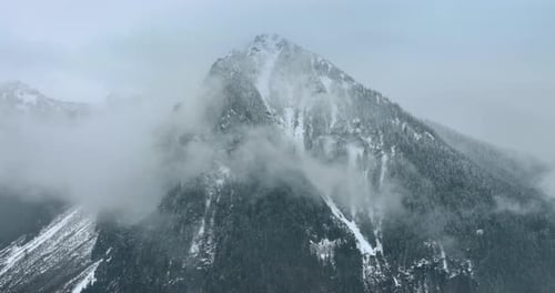 Approaching the gorgeous snow-capped mountain coated with haze.