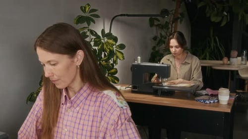 Young Caucasian Women Working on Sewing Machines at Workshop