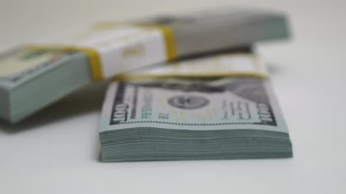 Stack of Bank Bundles with US Dollars on a White Background Closeup Shot of New Freshly Printed