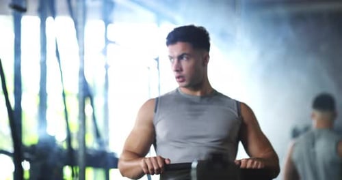 Gym, workout and man with rowing machine for fitness, training and muscle health with challenge