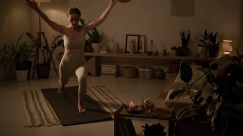 Auburn Haired Woman Practicing Yoga Indoors