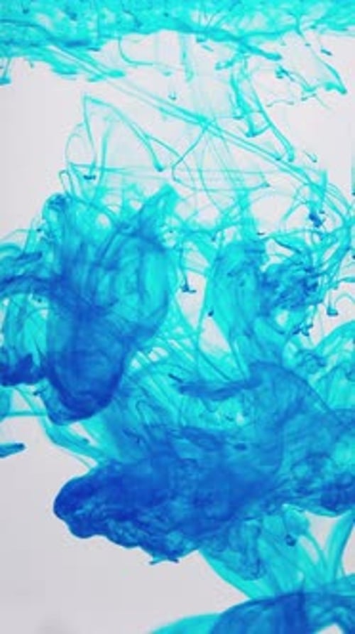 Blue Ink Drops and Swirls Underwater