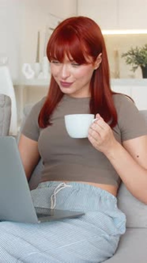 Young Woman with Coffee Cup Checks Email on Laptop Works Freelance Remote Tasks Client Inbox Replies