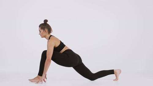 Young Woman in Black Activewear Performs Yoga