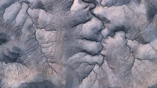 Surface background, far away planet with cracks and river beds, top down aerial