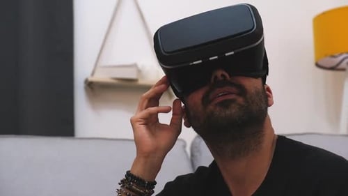 Young Adult Using Virtual Reality Headset in Home