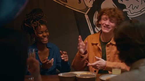 Man Telling Funny Story to his Friends While Celebrating Birthday in bar