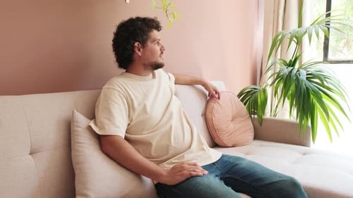 Man Resting Peacefully on Couch Indoors