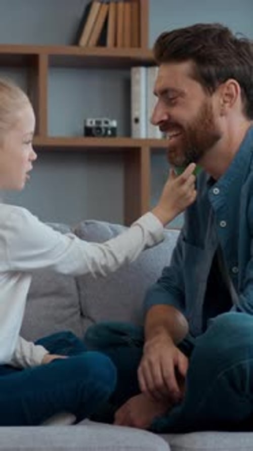 Happy Caucasian Family at Home Daughter with Father Talking on Couch Cute Child Girl Playing with