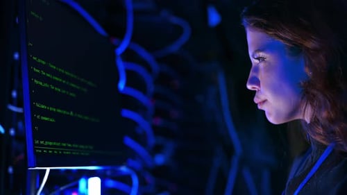 Woman programming in a server room