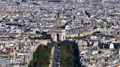 Aerial Slide and Pan Shot of Arc De Triomphe Massive Historic Arc in Middle of Round Square Dense