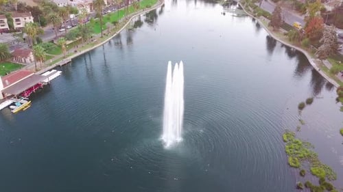LA: Drone shot of Echo Park Lake and Fountain with Downtown Skyscrapers in the distance at sunset
