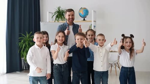 Standing together, showing gestures and having fun. Group of children students in class at school