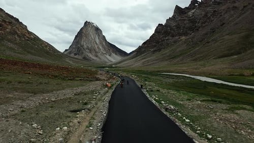 Motorcycles Riding On Scenic Road Toward Rock Peak Aerial View