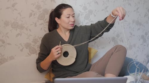 Woman Crocheting at Home on the Couch