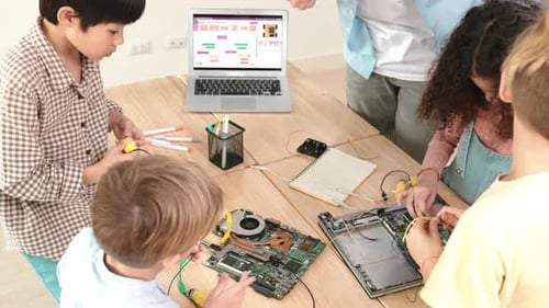 Children learning coding and electronics in classroom setting