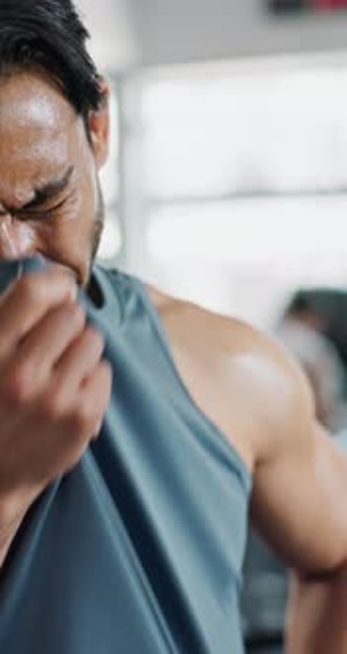 Man, sweating and tired in gym for fitness with deep breathing, burnout