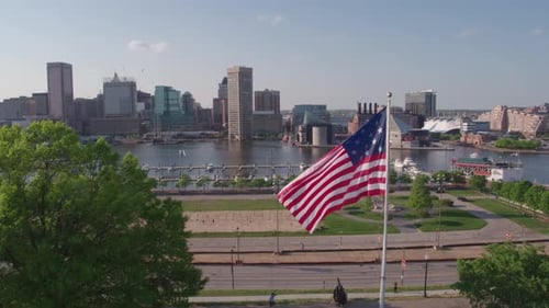 Drone shot over Baltimore Inner Harbor and American Flag