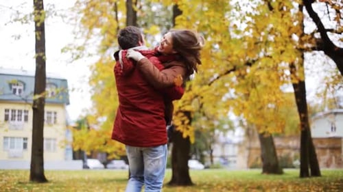 Couple Embrace and Spin in Autumn Park Setting