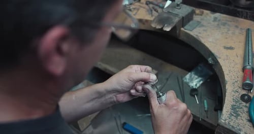 Jeweler Polishes a Ring During the Making Process in a Workshop