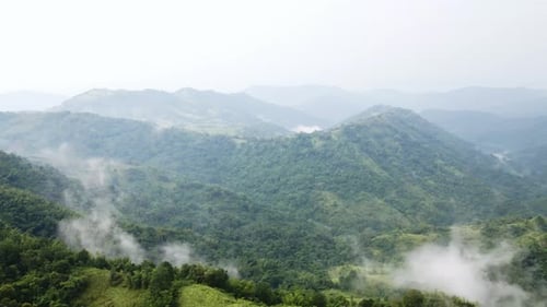 Aerial shot view of mountains peaks with clouds landscape.