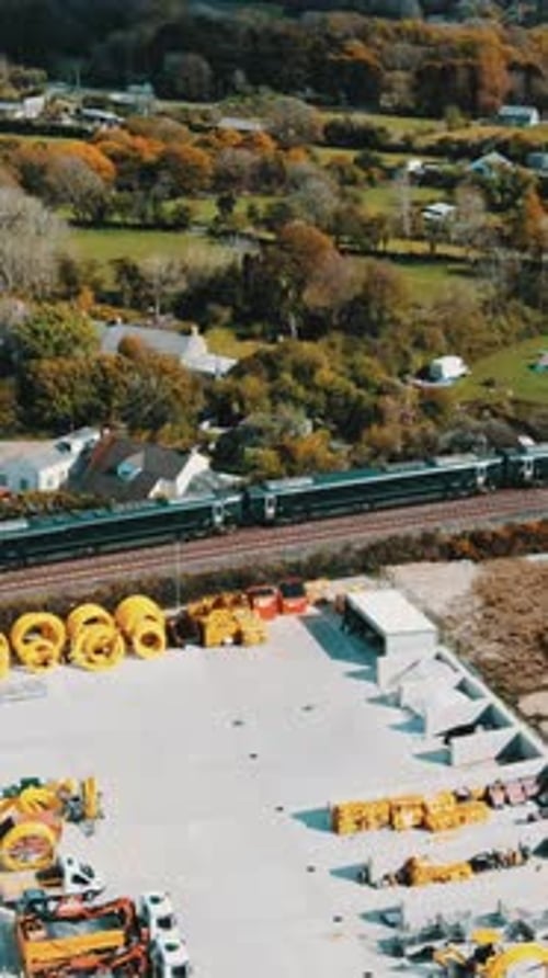 The suburban train is moving on the track Beautiful country landscape. Vertical video