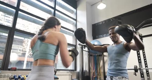 Woman Boxing Training at Gym With Personal Trainer