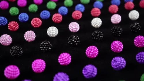 Colorful Beaded Spheres on Black Surface