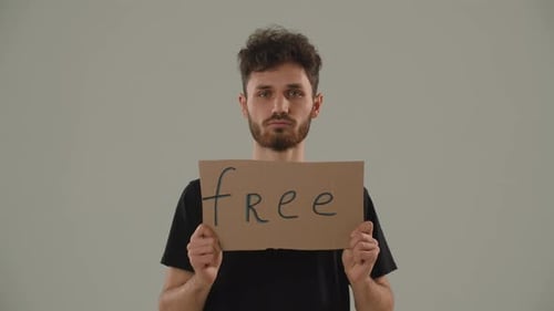 A Young Curlyhaired Man Opposes Oppression War and Occupation A Man in a Black Tshirt Stands on a