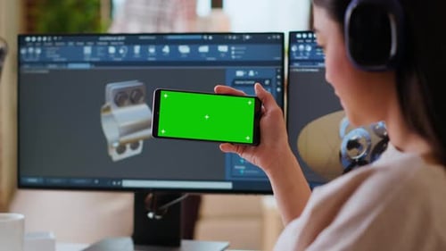 Software Developer Works in a Modern Office with Green Screen and Dual Monitors
