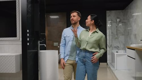 Couple Choosing Bathroom Fixtures with Consultant Advice in Showroom