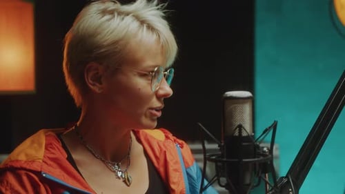 Woman Talking in Microphone during Podcast Interview in Recording Studio