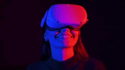 Woman Smiles Wearing VR Headset with Red and Blue Lights