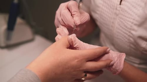Manicure Process: Nail Technician Filing Nails