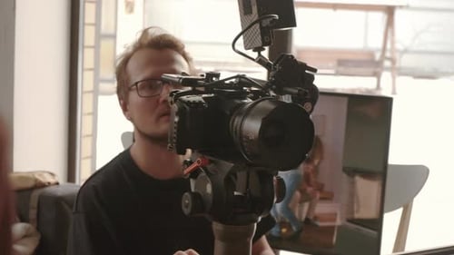 Camera Operator Recording Video Indoors