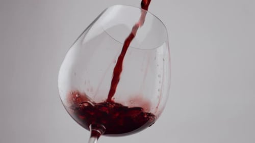 Crystal Goblet Filled Red Wine on White Background Close Up. Stream Delicious