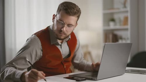 Young Adult Man Working at Laptop