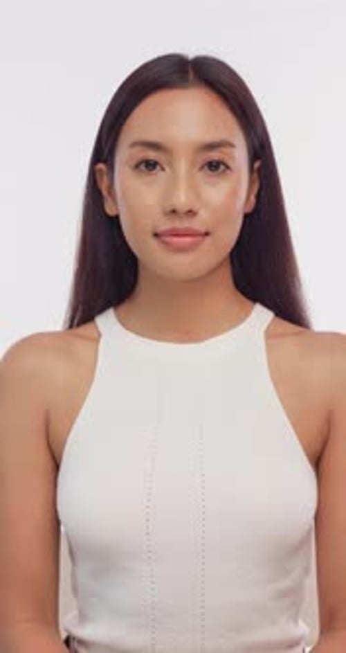 Beautiful Woman Poses in White Top Against Background