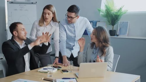 Team Collaborating at a Table in Office Setting