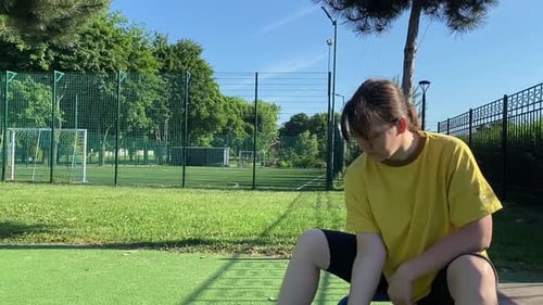 Young woman works out at the sport area outdoors