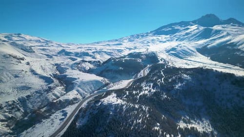 Snowy Mountain Road Through a Winter Landscape