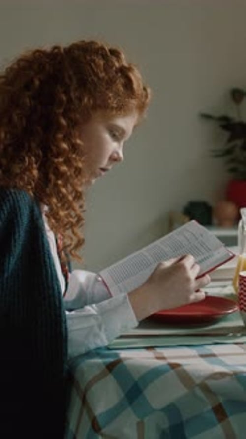 Focus and Introspection A Young Girl Concentratedly Reading at the Breakfast Table Full of Life