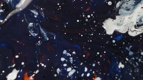 White Ink Drops on Dark Blue Orange Background
