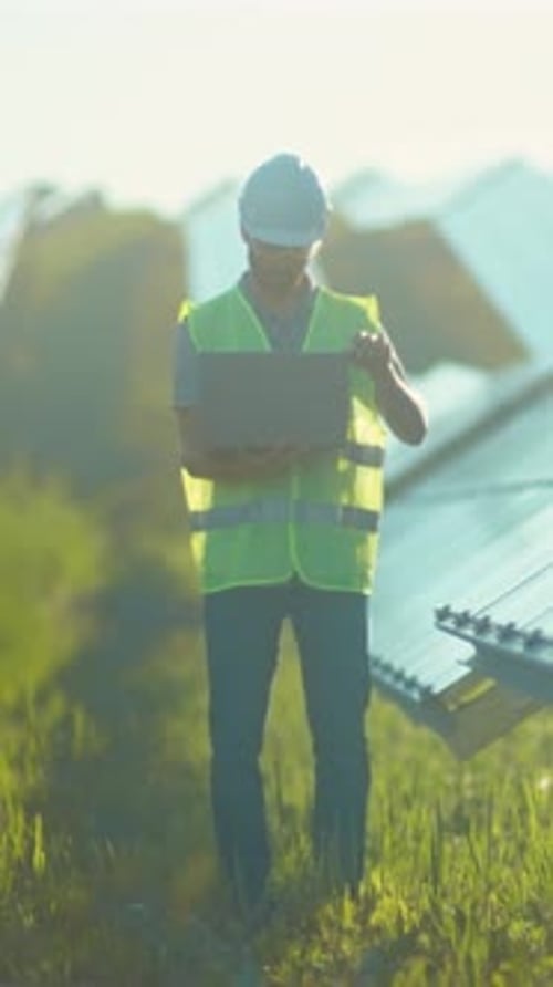 Sunlight Inspection for Energy Systems Technician Evaluating Photovoltaic Modules While Recording