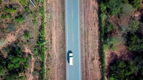 Overhead View Of A Vehicle Driving Through Two-lane Road In Africa. - aerial