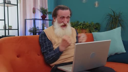 Overjoyed Senior Man Working on Laptop Celebrate Success Win Money in Lottery Get Online Good News