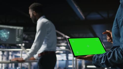 Server Hub Engineers Finetuning Configurations Using Chroma Key Device Close Up