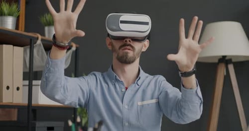 Slow Motion Portrait of Businessman Wearing Augmented Reality Glasses Moving Hands in Office
