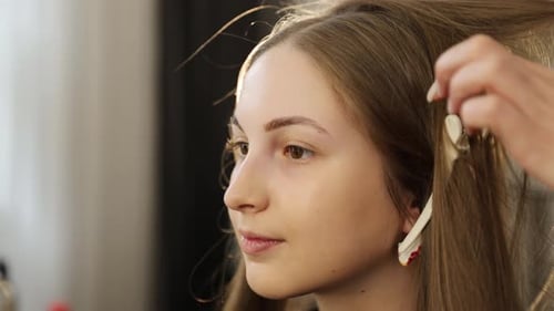 Woman getting makeup applied at home